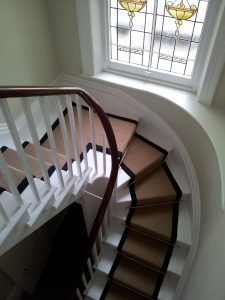 Jute boucle with black linen border fitted to winding stairs and quarter landing