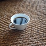 Coir Herringbone natural carpet & a cup of black coffee