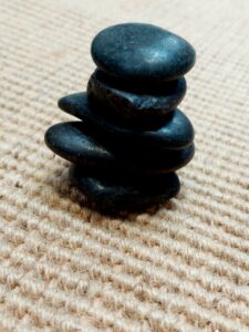 Jute-boucle-flooring-close-up-with-stones-demonstrating-wabi-sabi