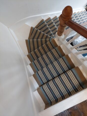 Seaspray-pastel-blue-and beige-striped-stairrunner-with-stone-beige-borders-to-winding-stairs