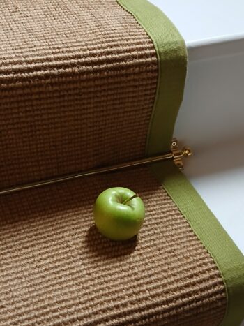 Jute-stairrunner-with-green-border-staged-with-a-fresh-green-apple